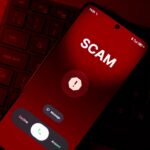 A modern smartphone screen showing a missed call from an unknown international number with a red warning icon overlay, dark blurred background, cybersecurity and phone scam concept, realistic lighting, high detail, shallow depth of field