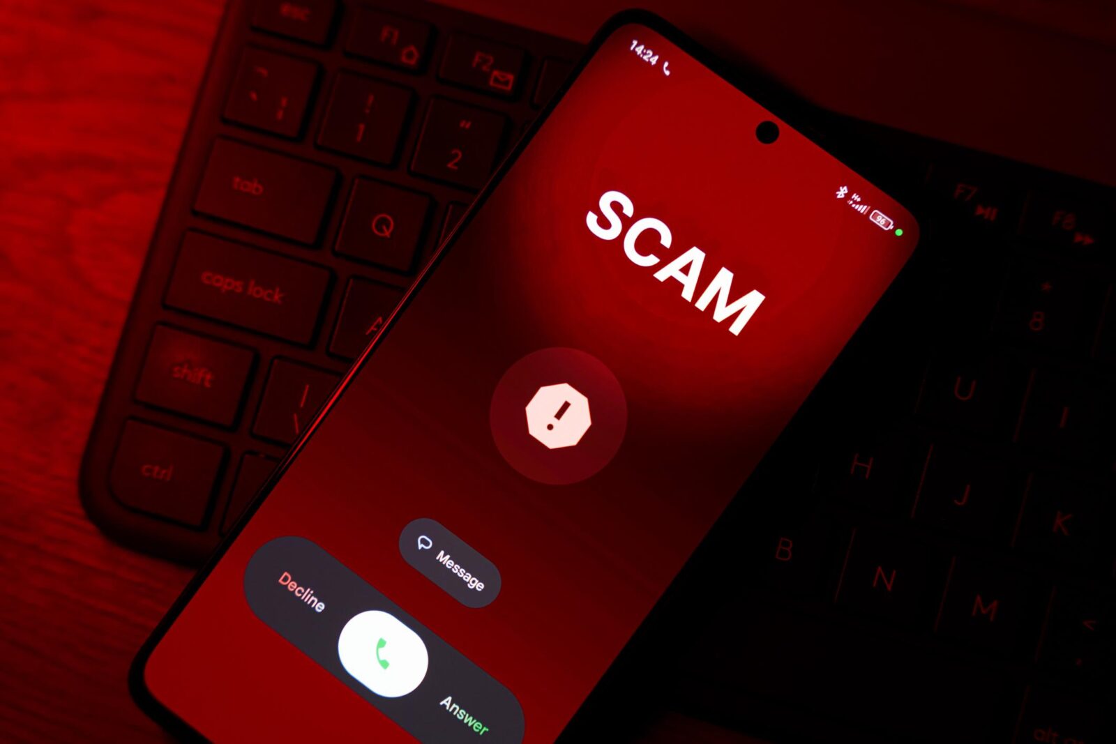 A modern smartphone screen showing a missed call from an unknown international number with a red warning icon overlay, dark blurred background, cybersecurity and phone scam concept, realistic lighting, high detail, shallow depth of field